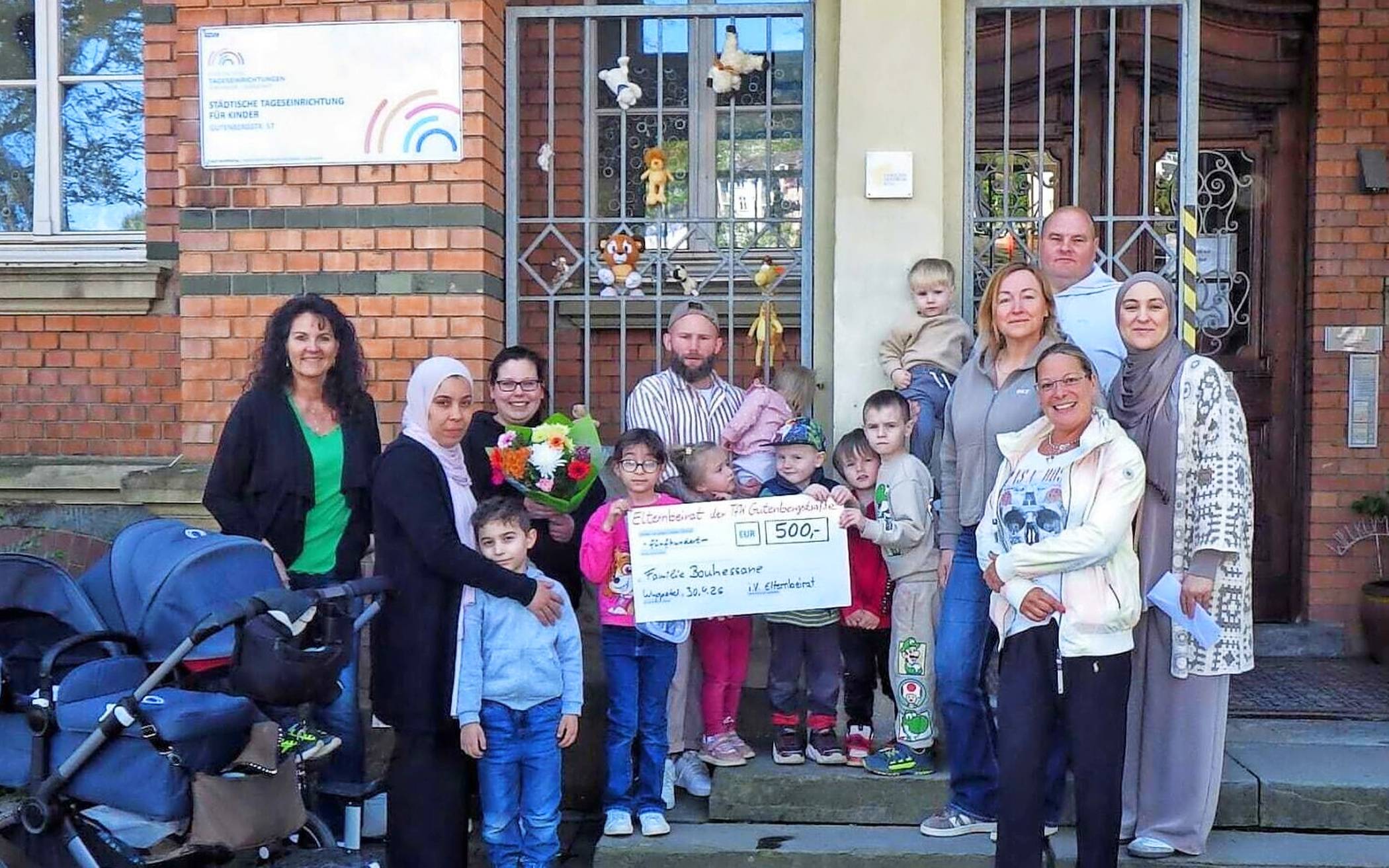  Die betroffene Familie mit Eltern und Kindern des Elternbeirates sowie der Einrichtungs- und Gruppenleitung. 