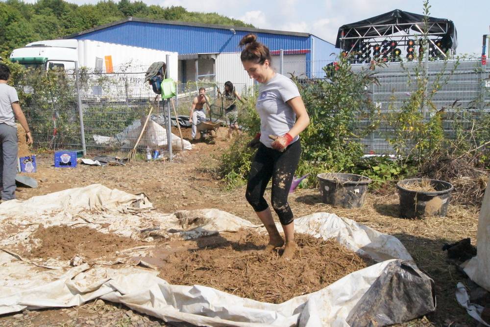  Mit vollem Einsatz sorgt Cristina Sopena Amiel für das richtige Mischungsverhältnis von Lehm und Stroh. Am Mirker Bahnhof übten die Studenten seit dem Sommer für den Echt-Einsatz in Nicaragua. 
