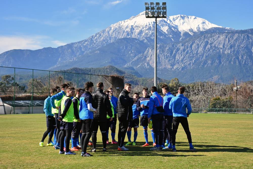  Trainer Stefan Vollmerhausen (Mitte) mit seinem Team vor idyllischem Ambiente. 