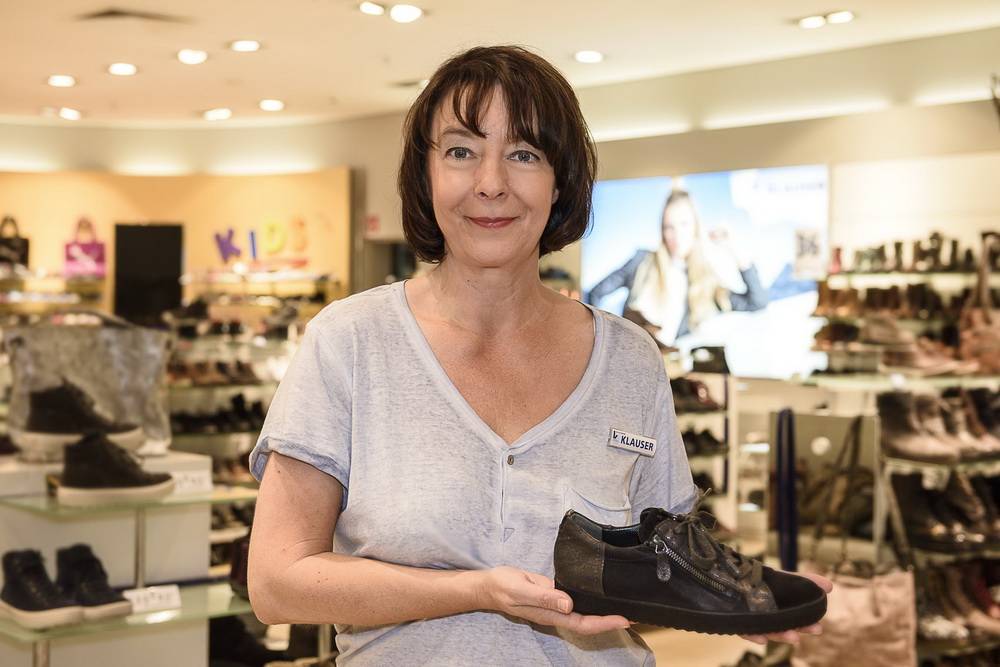  Gabriele Hink zeigt einen trendigen Sneaker. Vor 15 Jahren musste sie mit ihren Kolleginnen die Schuhe von Hand transportieren. 