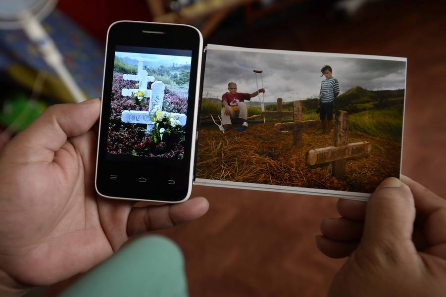  Fassungslos stehen Ronolfo P. Robin (45) und seine Frau Shara Jean B. Pedano (30) vor den Gräbern ihrer drei Kinder. Das Handy-Foto zeigt die Gräber ein Jahr später. „Die Menschen sind noch immer zutiefst traumatisiert“, sagt Jens Grossmann. 