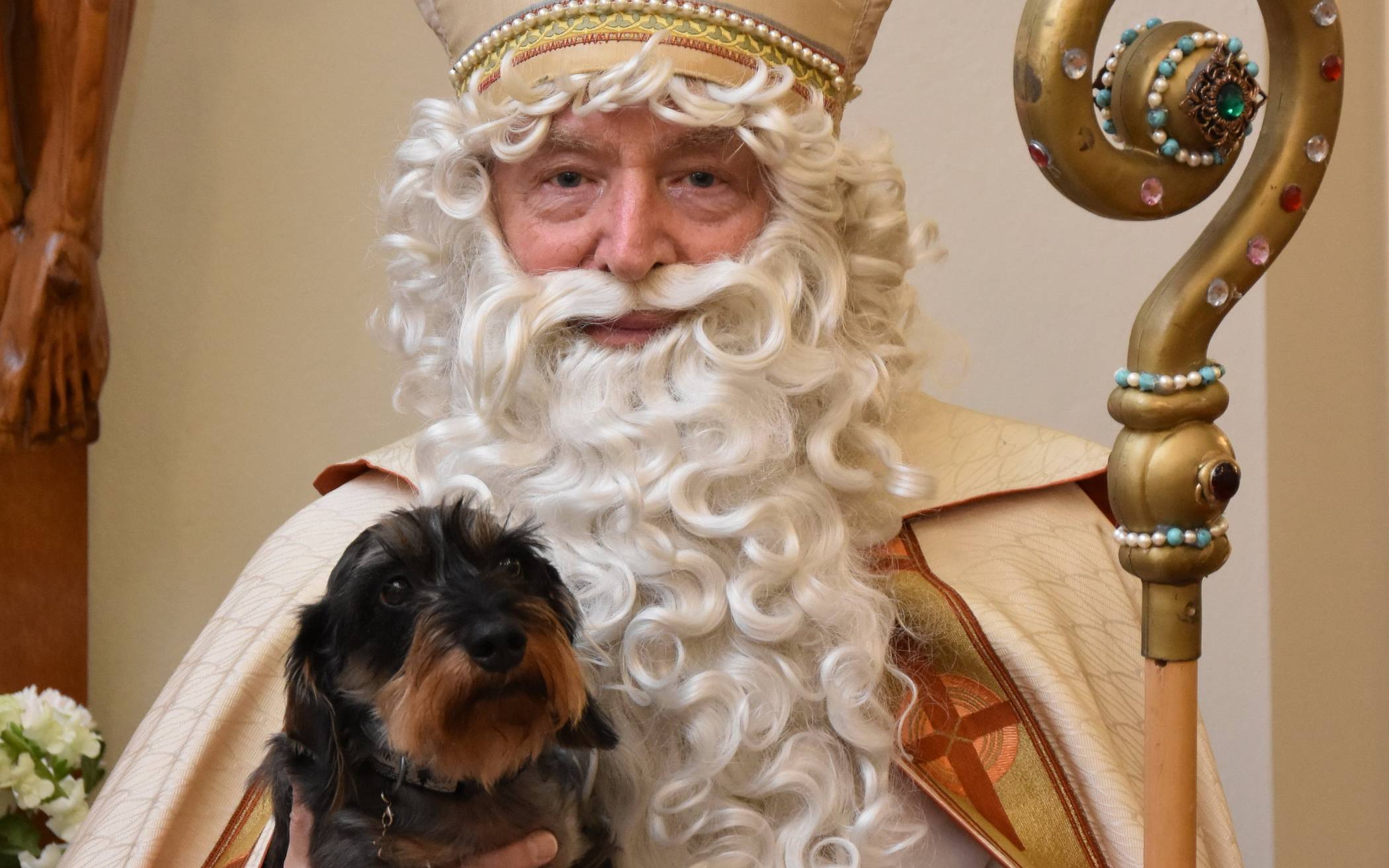 Der Bischof mit dem Hund auf dem Arm